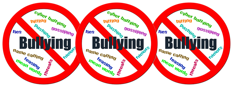 Photo of a red circle with the word 'Bullying' in the center of it and a red line going diagonally through the word 'Bullying'. In the background of the circle are words like pushing, hitting, threats, name calling, etc. There are three of these circles side by side.